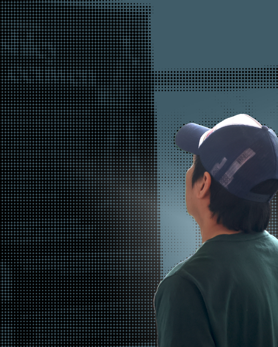 A man observes an exhibit in halftone.